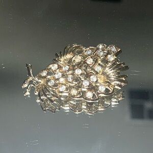 Antique golden brooch with rhinestone